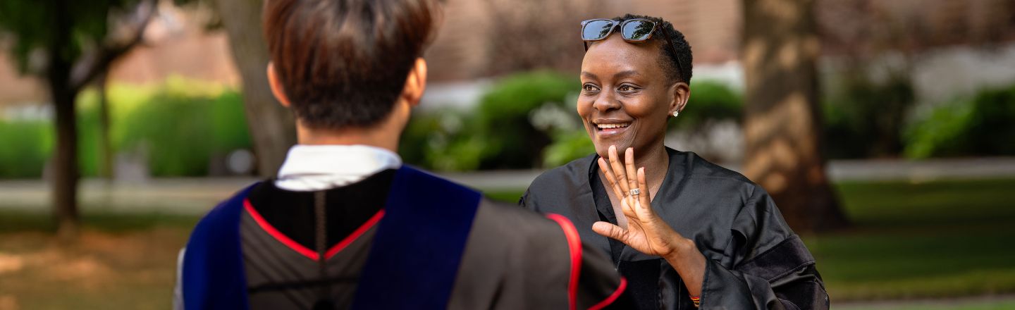 Emma Ariyo waves at colleague