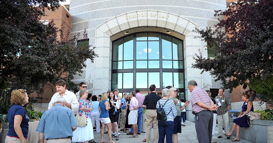 Front of ������ Law School with many people walking around.