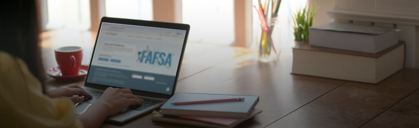 Student on a laptop with FAFSA web page open