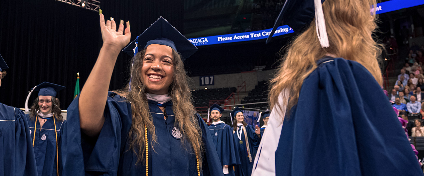 A Gonzaga student waves to crowd during Commencement.