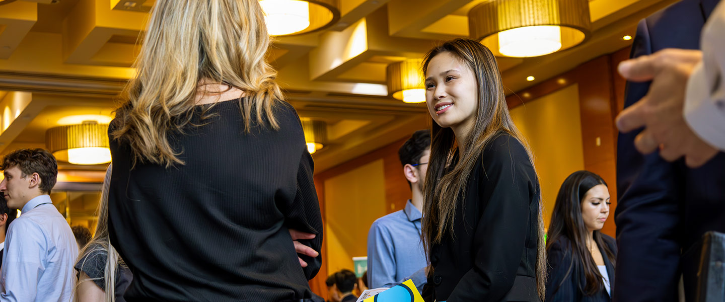 Individuals dressed in business attire networking